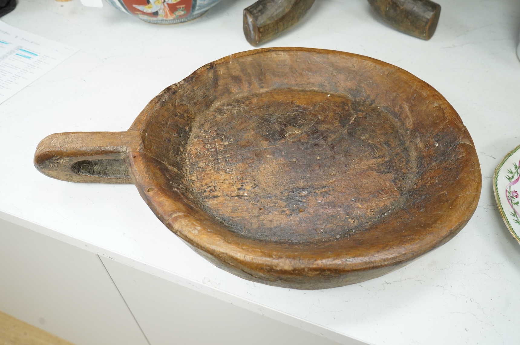 An Ethiopian tribal three footed stool and a carved handled bowl, stool 33cm high